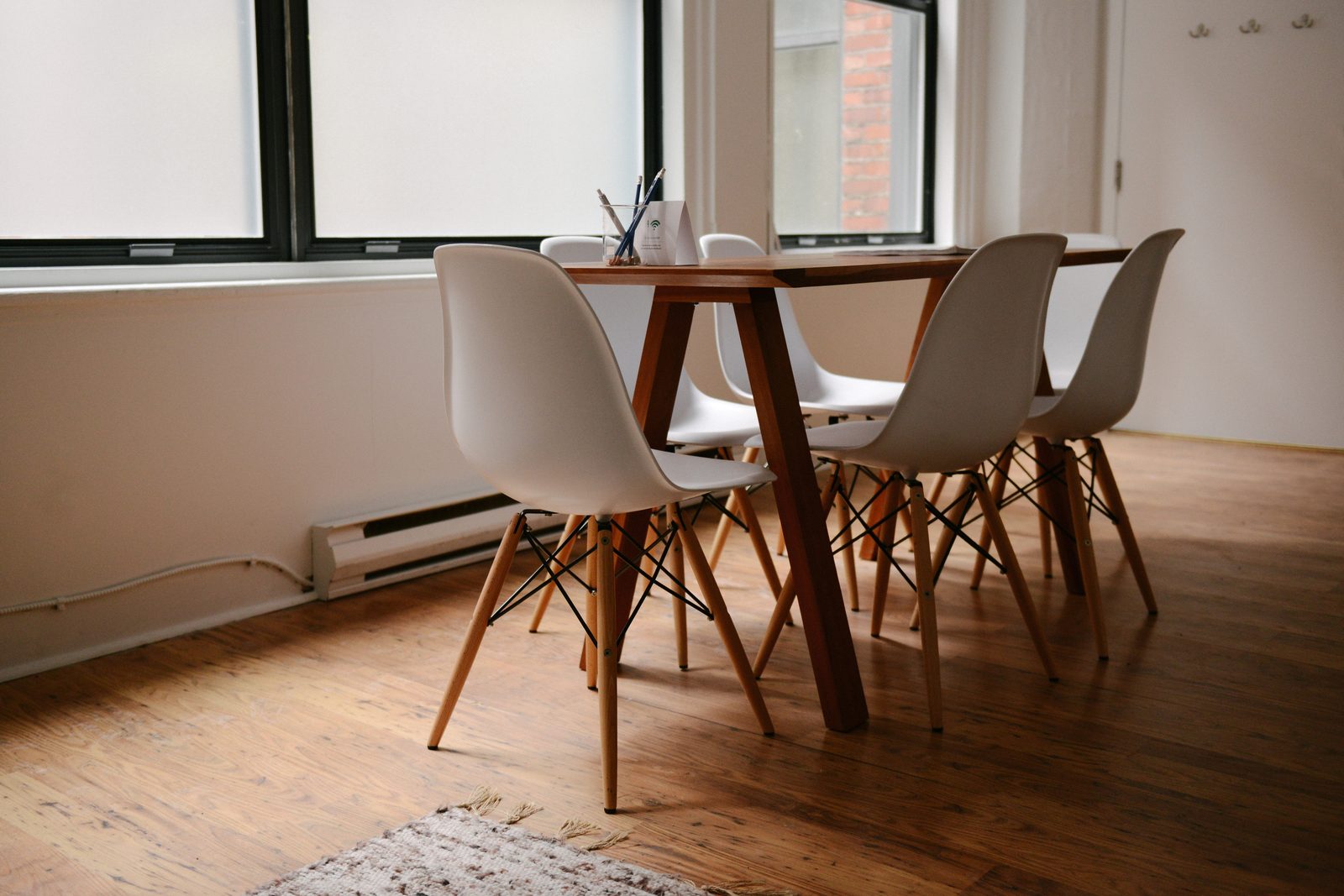 Empty boardroom with chairs around a meeting table, where directors weigh funding options for the company
